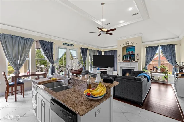 a living room with furniture a flat screen tv and a large window