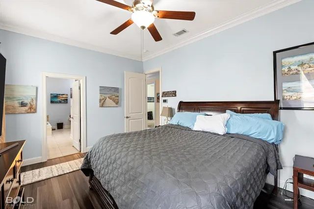 a bedroom with a large bed and a chandelier