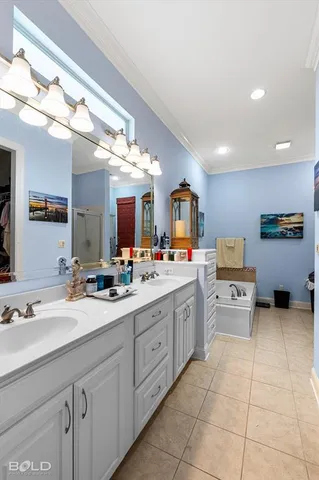 a large white kitchen with cabinets