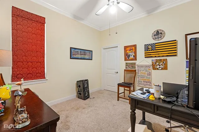 a view of a workspace with furniture and a window