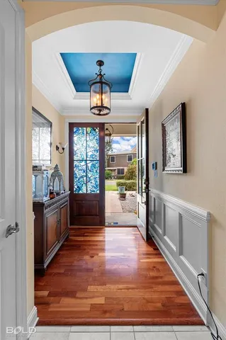 a large hall with stainless steel appliances granite countertop a stove and refrigerator