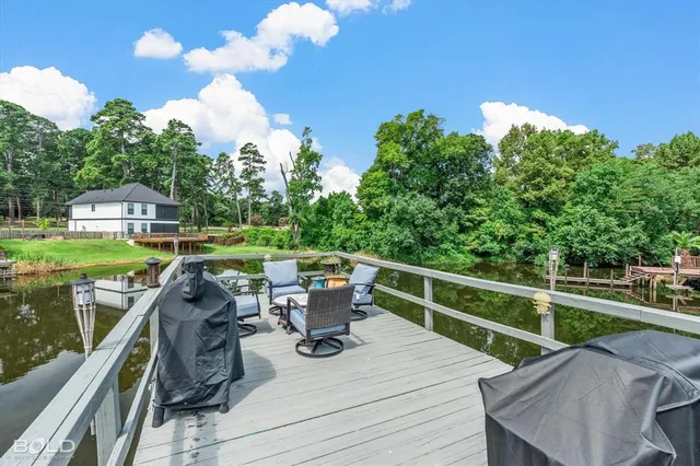 a view of a deck with couches table and chairs and potted plants