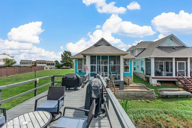 a view of a house with backyard sitting area and garden