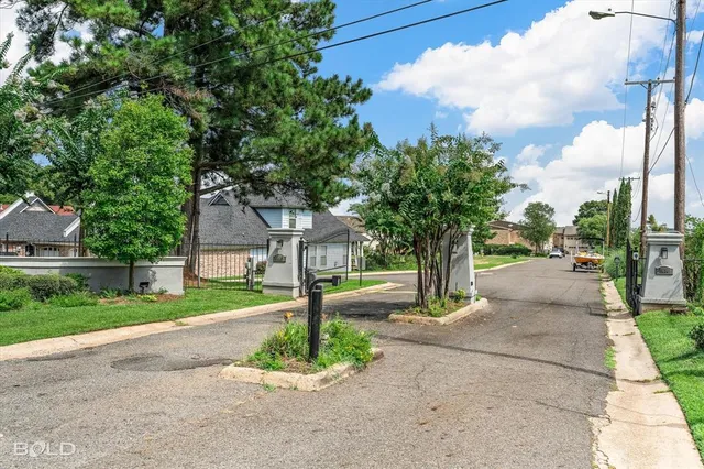 a front view of a house with swimming pool garden and patio