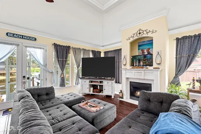 a living room with furniture a flat screen tv and a fireplace
