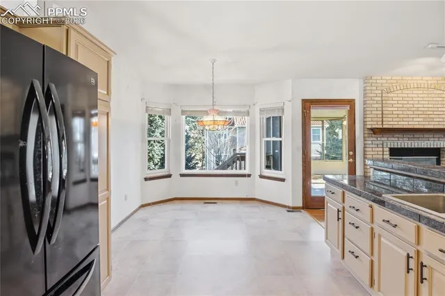 a large kitchen with cabinets a sink and a refrigerator
