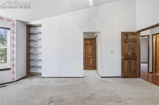 an empty room with windows and an empty room