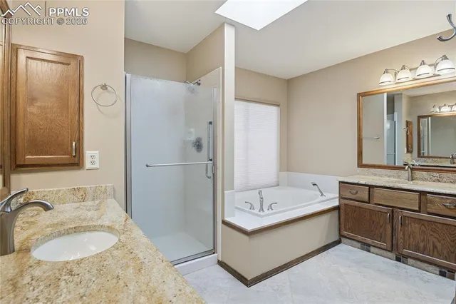 a bathroom with a tub double sink and mirror