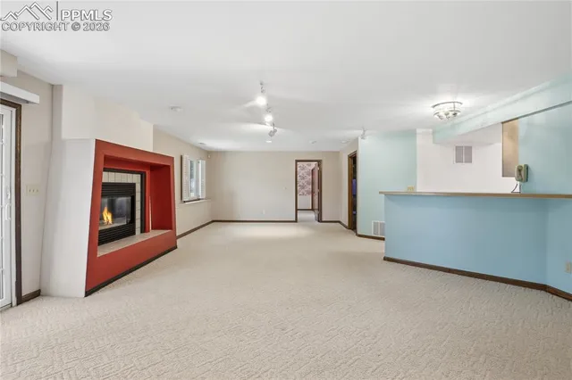 a view of an empty room with a kitchen