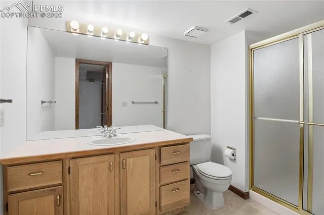a bathroom with a toilet a sink a vanity and mirror