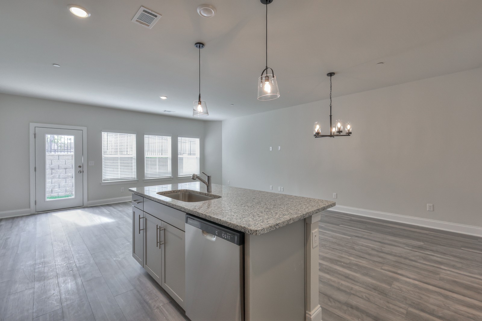 204 Douglas Bend Road, Unit 902 Gallatin, TN 37066 - Photo 13 of 32 a kitchen with stainless steel appliances granite countertop a sink a counter space and wooden floor