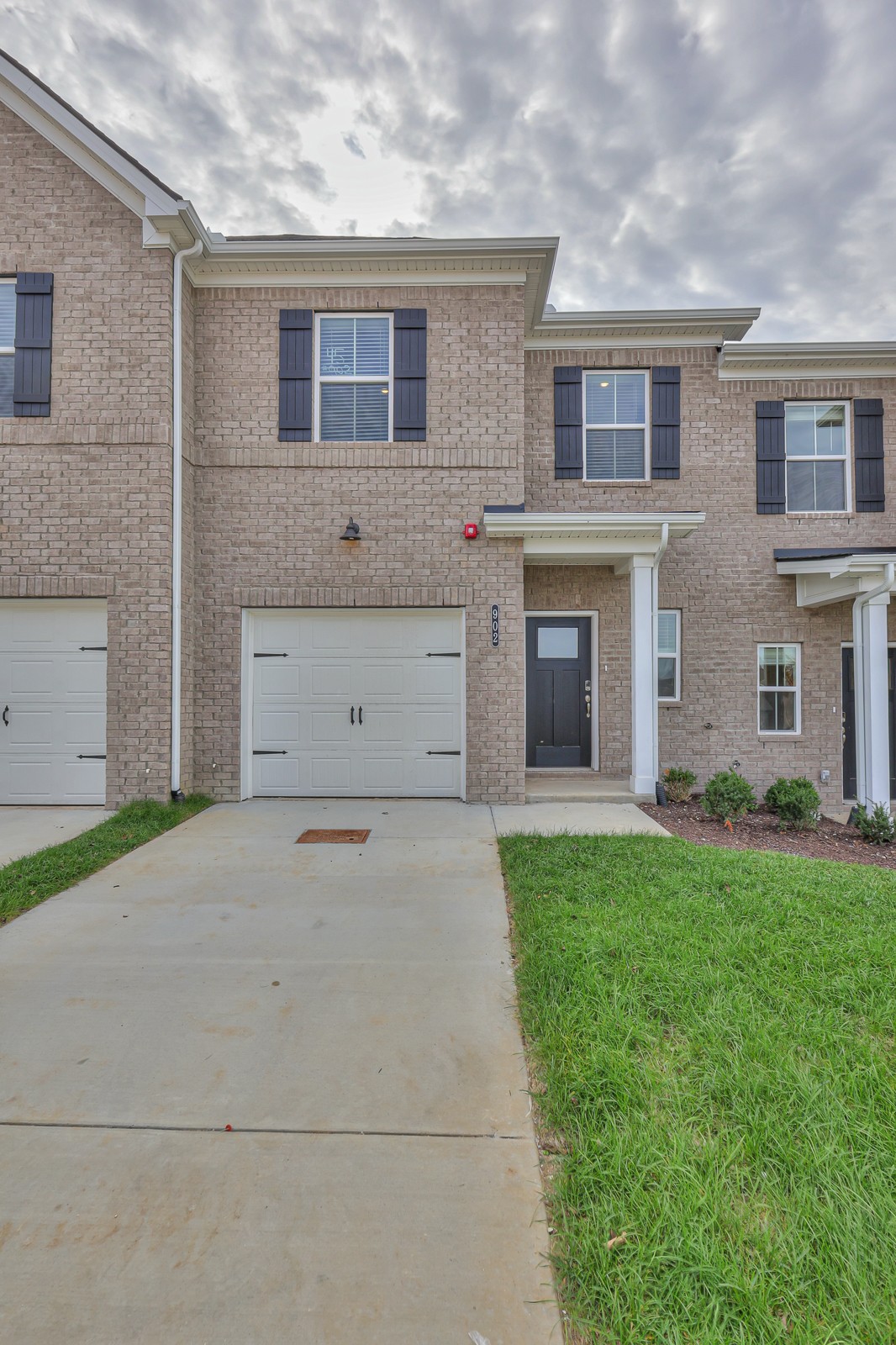 204 Douglas Bend Road, Unit 902 Gallatin, TN 37066 - Photo 2 of 32 a view of a house with a yard and a garage