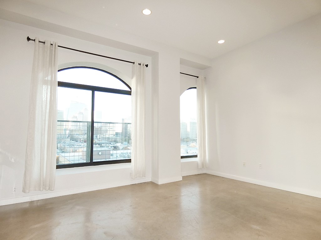 507 Sabine Street, Unit 704 Austin, TX 78701 - Photo 4 of 19 Oversized Arched Windows allow in tons of Natural Light with the larger Window offering a Juliet Balcony just outside.