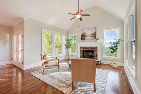 a living room with furniture fireplace and a large window