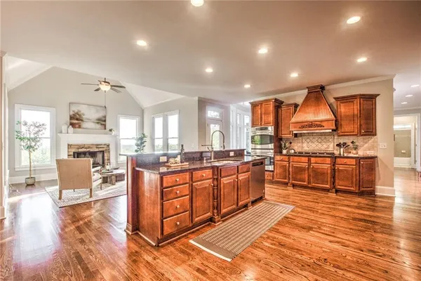 a view of a room with wooden floor and windows