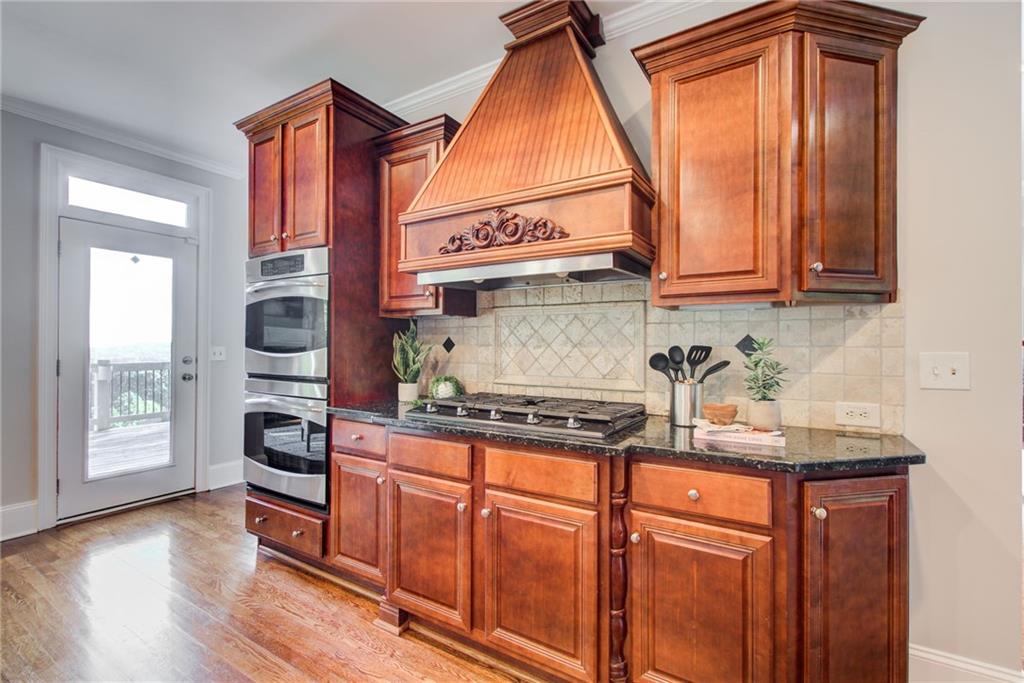 322 Tupelo Trail Canton, GA 30114 - Photo 24 of 118 a kitchen with stainless steel appliances granite countertop a stove and a sink