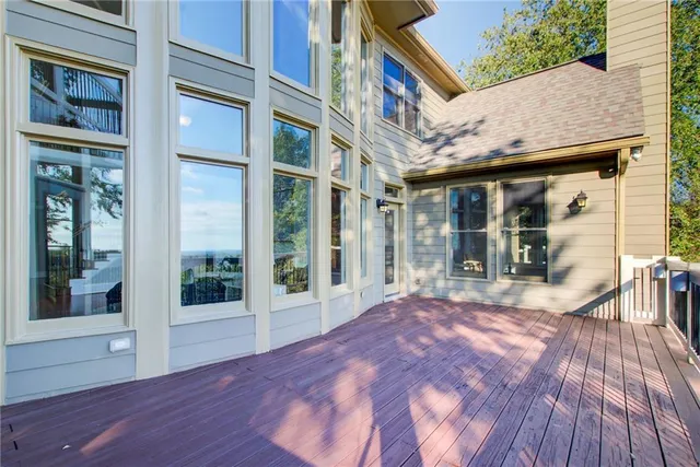 a view of a room that has a window and ceiling fan