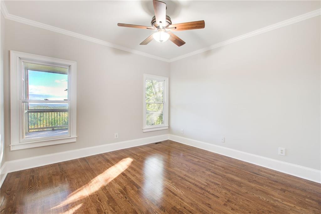 322 Tupelo Trail Canton, GA 30114 - Photo 36 of 118 a view of an empty room with wooden floor and a window