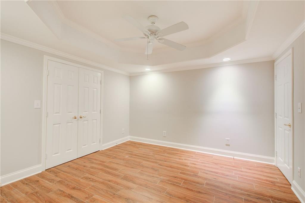 322 Tupelo Trail Canton, GA 30114 - Photo 70 of 118 a view of an empty room with wooden floor and a ceiling fan