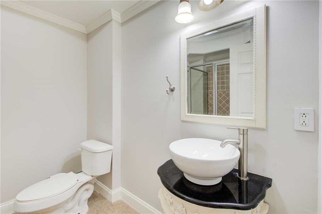 322 Tupelo Trail Canton, GA 30114 - Photo 72 of 118 a bathroom with a toilet a sink and a mirror