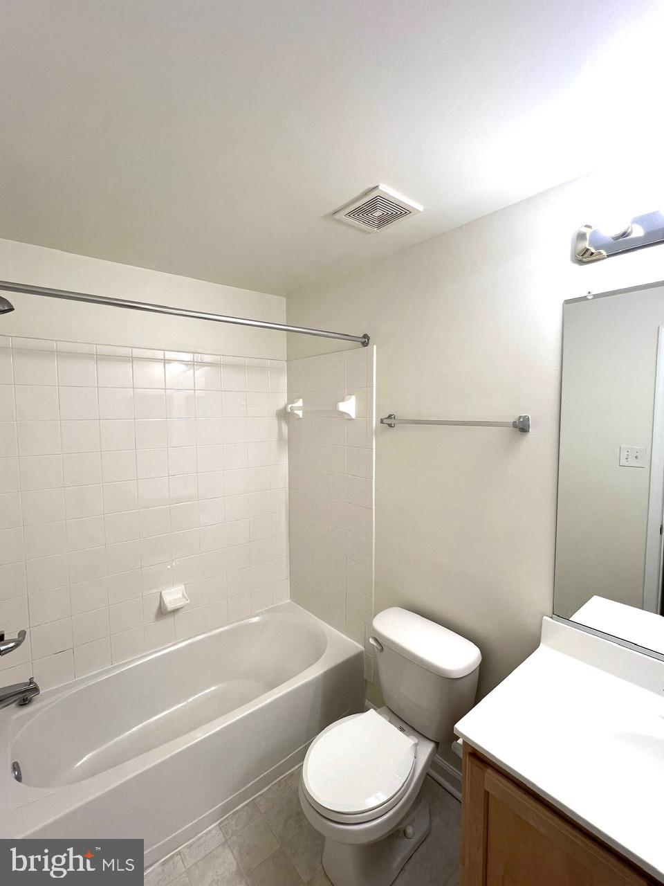 9702 Evening Bird Lane Laurel, MD 20723 - Photo 10 of 28 a white toilet and tub next to a bathroom sink