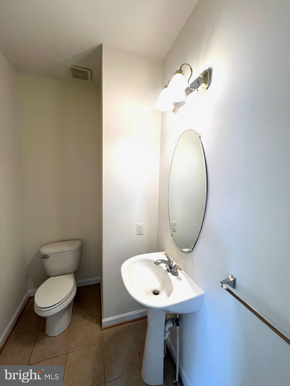 9702 Evening Bird Lane Laurel, MD 20723 - Photo 18 of 28 a bathroom with a toilet sink and mirror