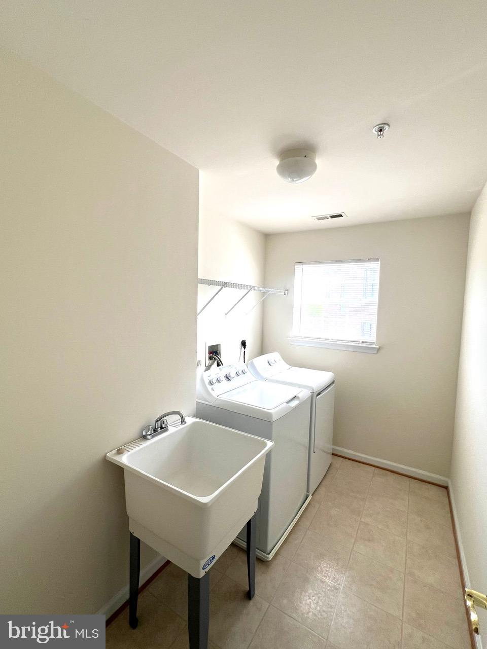 9702 Evening Bird Lane Laurel, MD 20723 - Photo 21 of 28 a view of a bathroom with a sink and a window