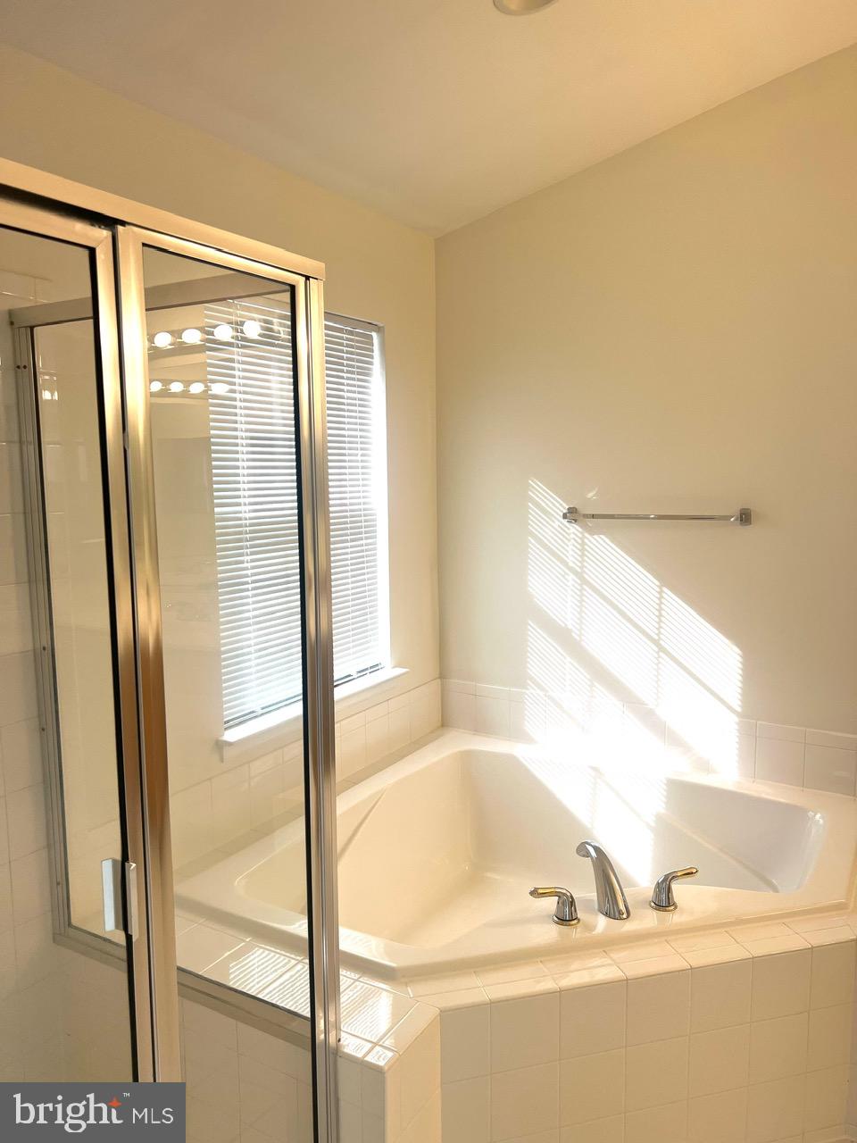 9702 Evening Bird Lane Laurel, MD 20723 - Photo 22 of 28 a bathroom with a bathtub and a shower