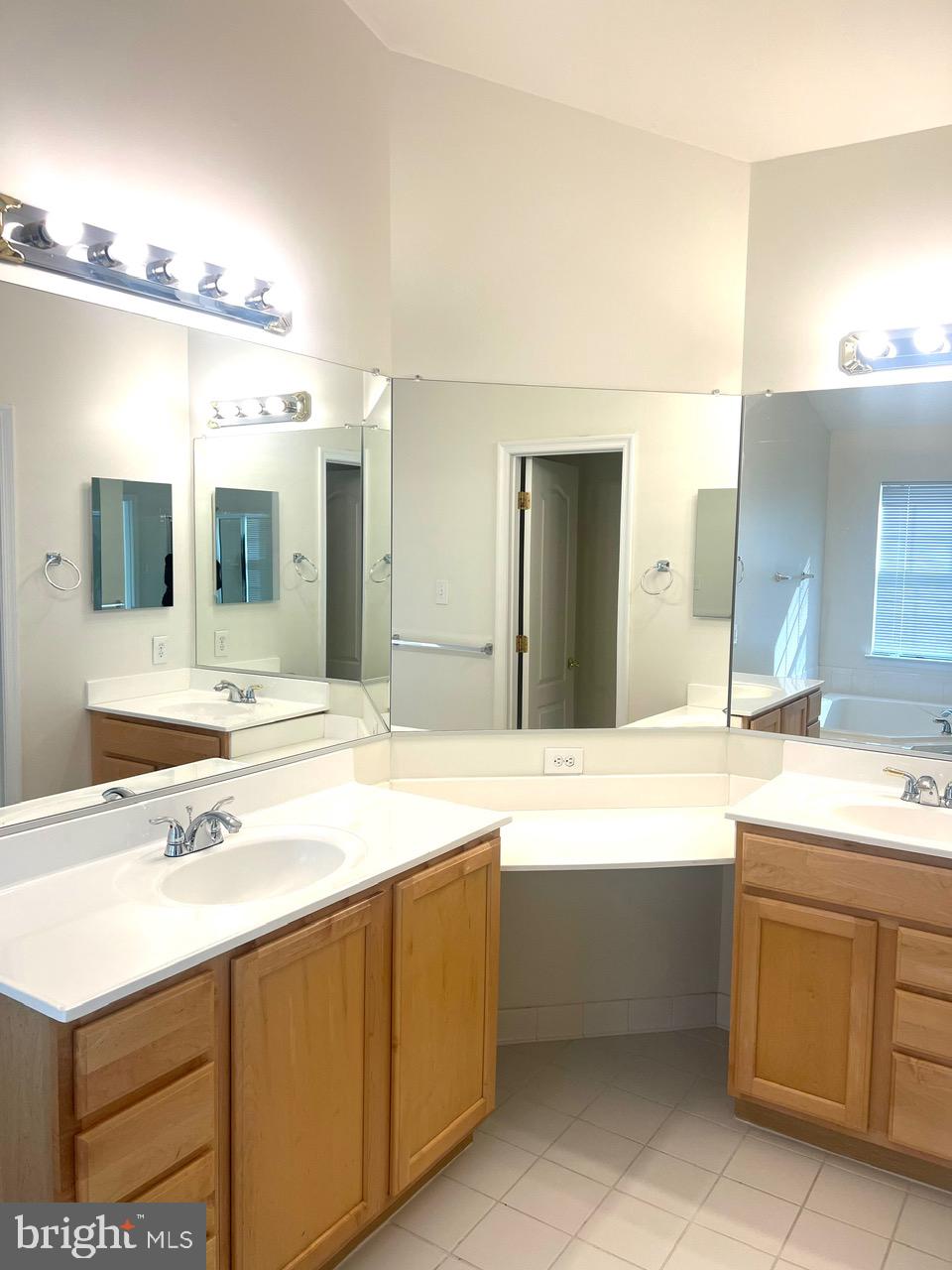 9702 Evening Bird Lane Laurel, MD 20723 - Photo 26 of 28 a bathroom with a sink double vanity and a mirror