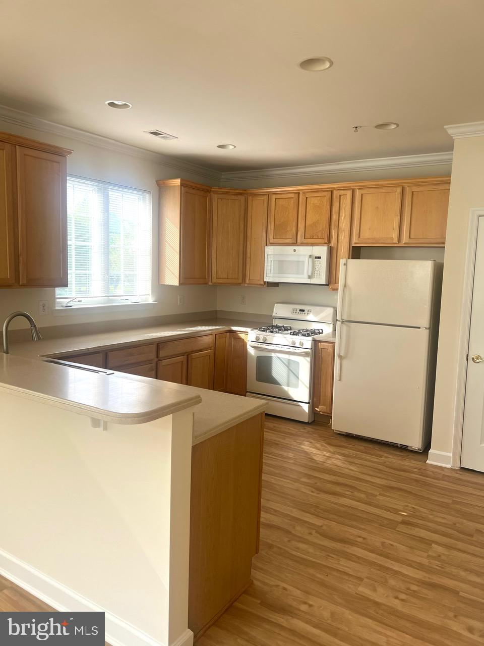 9702 Evening Bird Lane Laurel, MD 20723 - Photo 6 of 28 a kitchen with a cabinets a sink and wooden floor