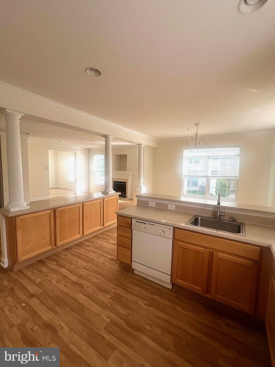 9702 Evening Bird Lane Laurel, MD 20723 - Photo 7 of 28 a large white kitchen with wooden floors and white walls