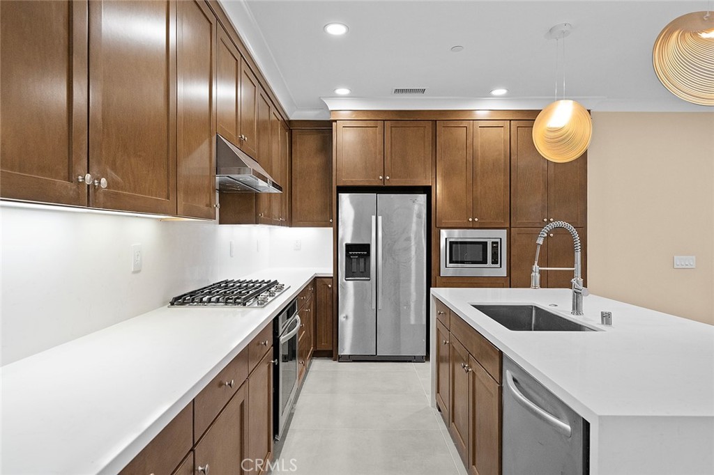 143 Rodeo Irvine, CA 92602 - Photo 11 of 37 a kitchen that has a lot of cabinets and stainless steel appliances