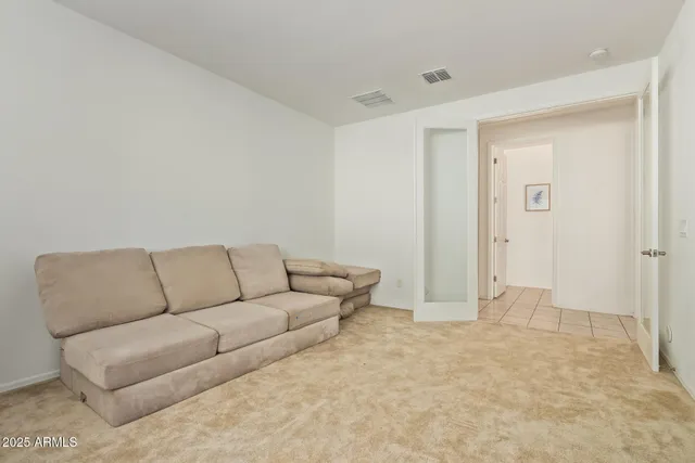 a living room with furniture and a white wall