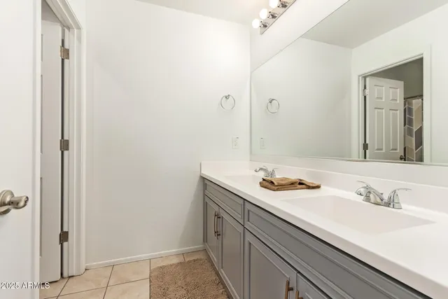 a bedroom with a bed that has a baby bed and a chair in it