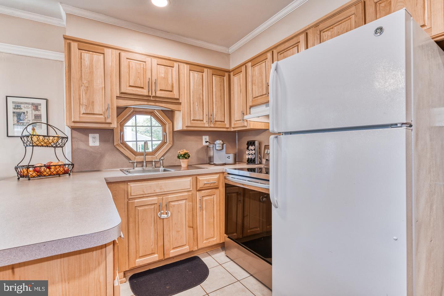 12 Goodturn Road Levittown, PA 19057 - Photo 4 of 20 a kitchen with stainless steel appliances granite countertop a refrigerator a stove a sink dishwasher and a refrigerator with wooden cabinets