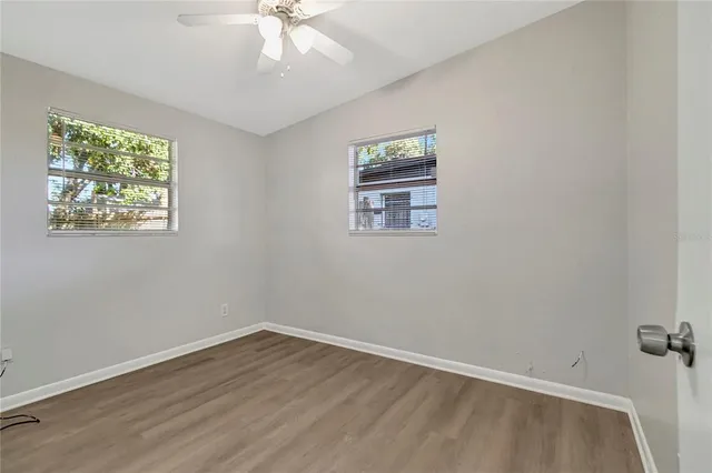 wooden floor in an empty room with a window