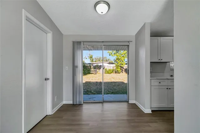 a view of a room with wooden floor and windows