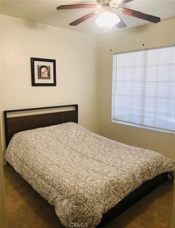 a bed sitting in a bedroom next to a window