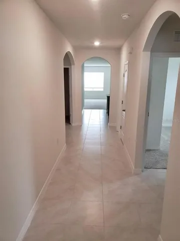 a view of kitchen with microwave stove top oven and cabinets