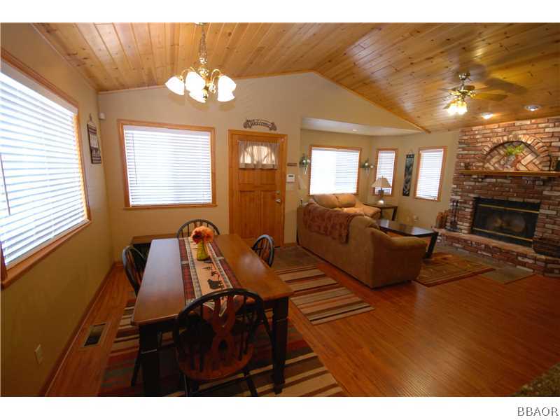 440 Riverside Avenue Sugarloaf, CA 92386 - Photo 17 of 23 a view of a livingroom with furniture a flat screen tv and wooden floor