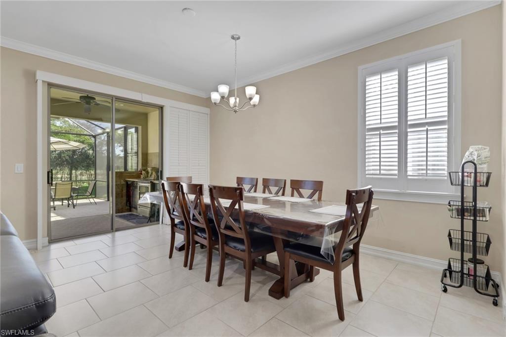 16309 Aberdeen Way Naples, FL 34110 - Photo 13 of 34 a view of a dining room with furniture and a chandelier