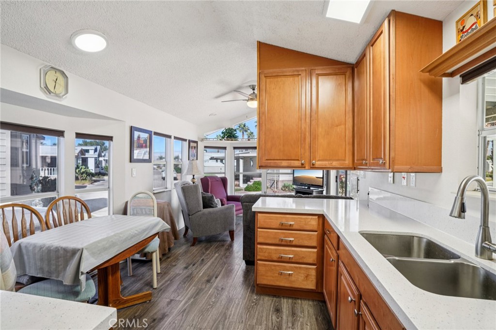 81620 Ave 49, Unit 174 Indio, CA 92201 - Photo 14 of 37 a kitchen that has a lot of cabinets a sink and wooden floor