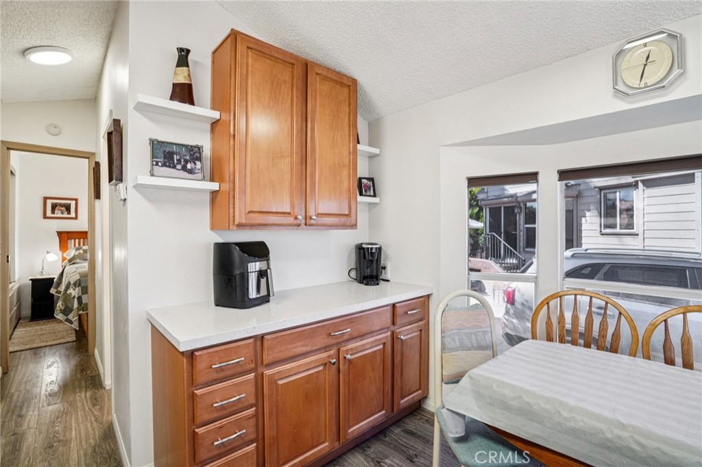 81620 Ave 49, Unit 174 Indio, CA 92201 - Photo 15 of 37 a kitchen with stainless steel appliances granite countertop a refrigerator a stove and a sink with wooden floor
