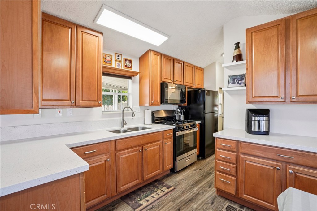 81620 Ave 49, Unit 174 Indio, CA 92201 - Photo 16 of 37 a kitchen with stainless steel appliances granite countertop a sink stove and refrigerator