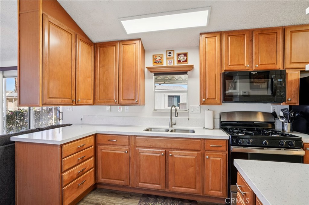 81620 Ave 49, Unit 174 Indio, CA 92201 - Photo 17 of 37 a kitchen with stainless steel appliances a sink stove and cabinets