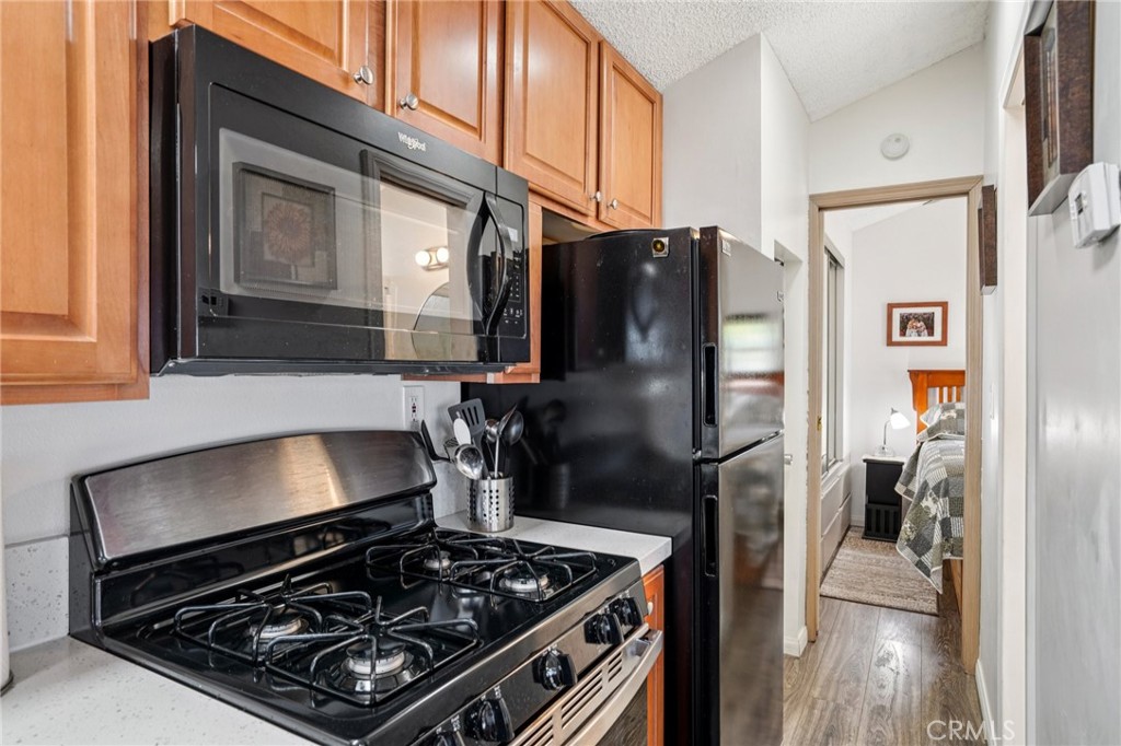 81620 Ave 49, Unit 174 Indio, CA 92201 - Photo 18 of 37 a kitchen with a stove and a refrigerator