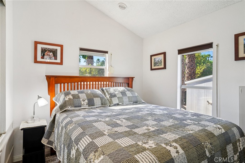 81620 Ave 49, Unit 174 Indio, CA 92201 - Photo 19 of 37 a bedroom with a large bed and a window