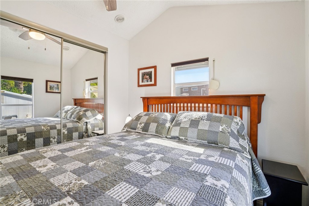 81620 Ave 49, Unit 174 Indio, CA 92201 - Photo 20 of 37 a bedroom with a large bed and a chandelier