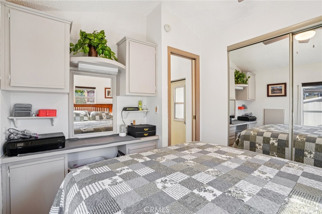 81620 Ave 49, Unit 174 Indio, CA 92201 - Photo 21 of 37 a bedroom with a bed and a large window