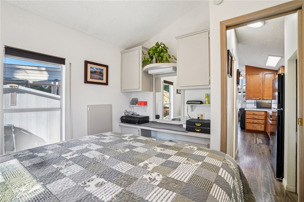 81620 Ave 49, Unit 174 Indio, CA 92201 - Photo 22 of 37 a bedroom with a bed and a view of living room